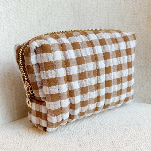 Plaid pouch with gold zipper on a beige background
