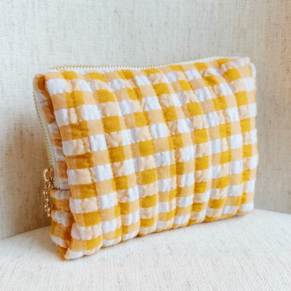 Yellow and white checkered pouch on a light background