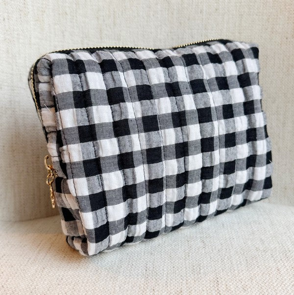 Black and white checkered clutch bag on a light background
