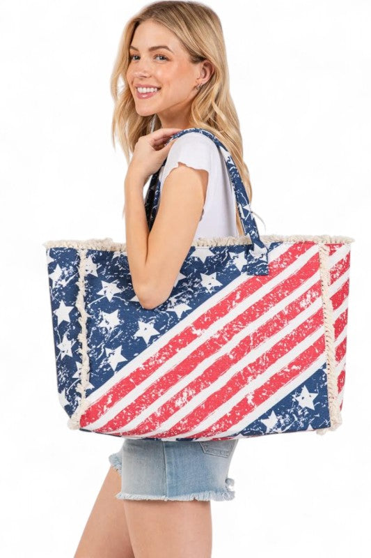 Woman holding a large tote bag with an American flag design on a white background
