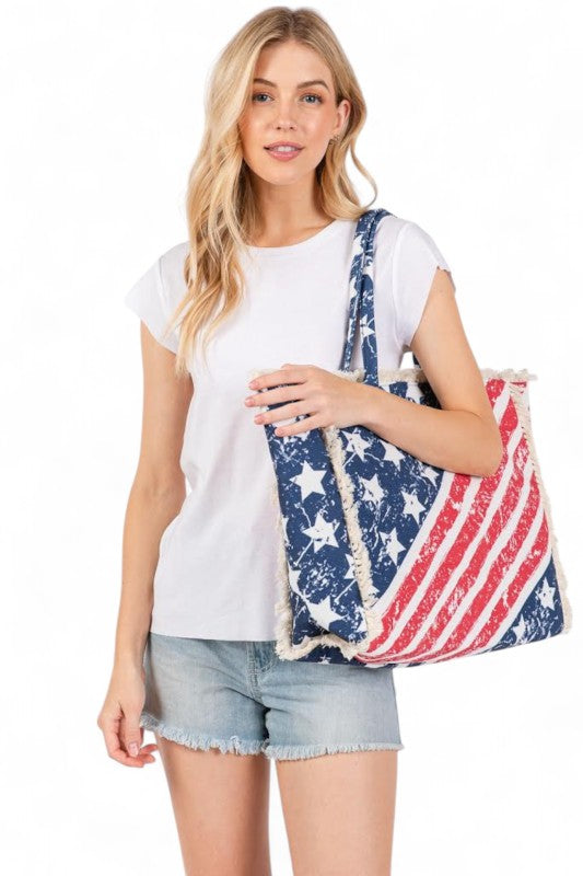 Woman holding a tote bag with American flag design on a white background