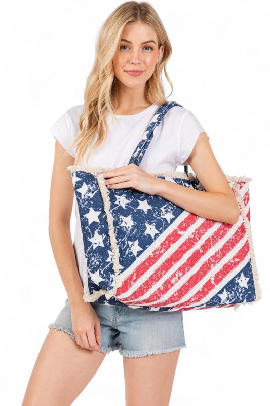 Woman holding a large American flag-patterned bag against a white background