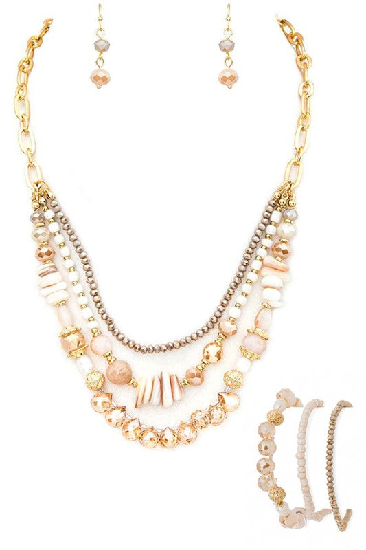 Multistrand beaded necklace with gold chain on a white background