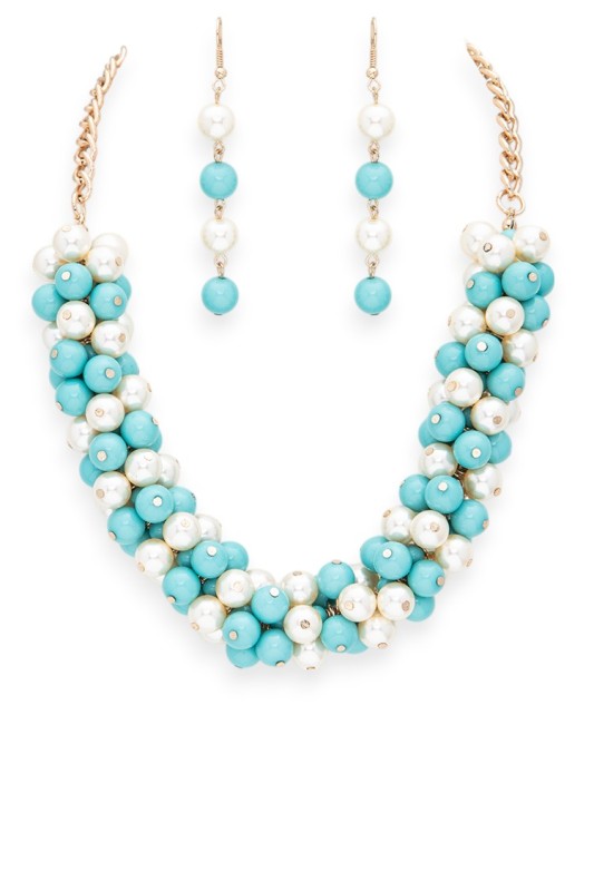 Necklace and earrings set with turquoise and white beads on a white background