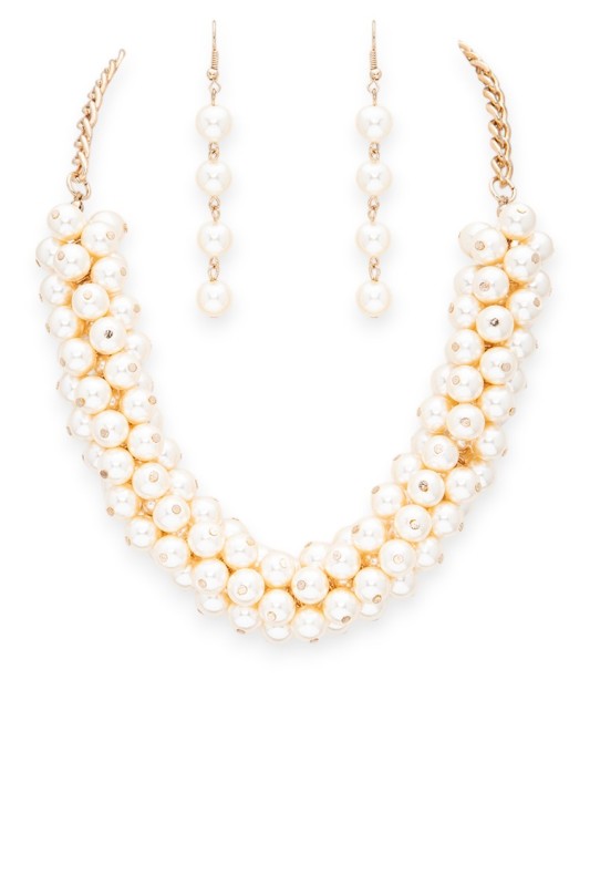 Pearl necklace with gold chain on a white background
