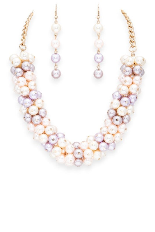 Pearl necklace and earrings set on a white background