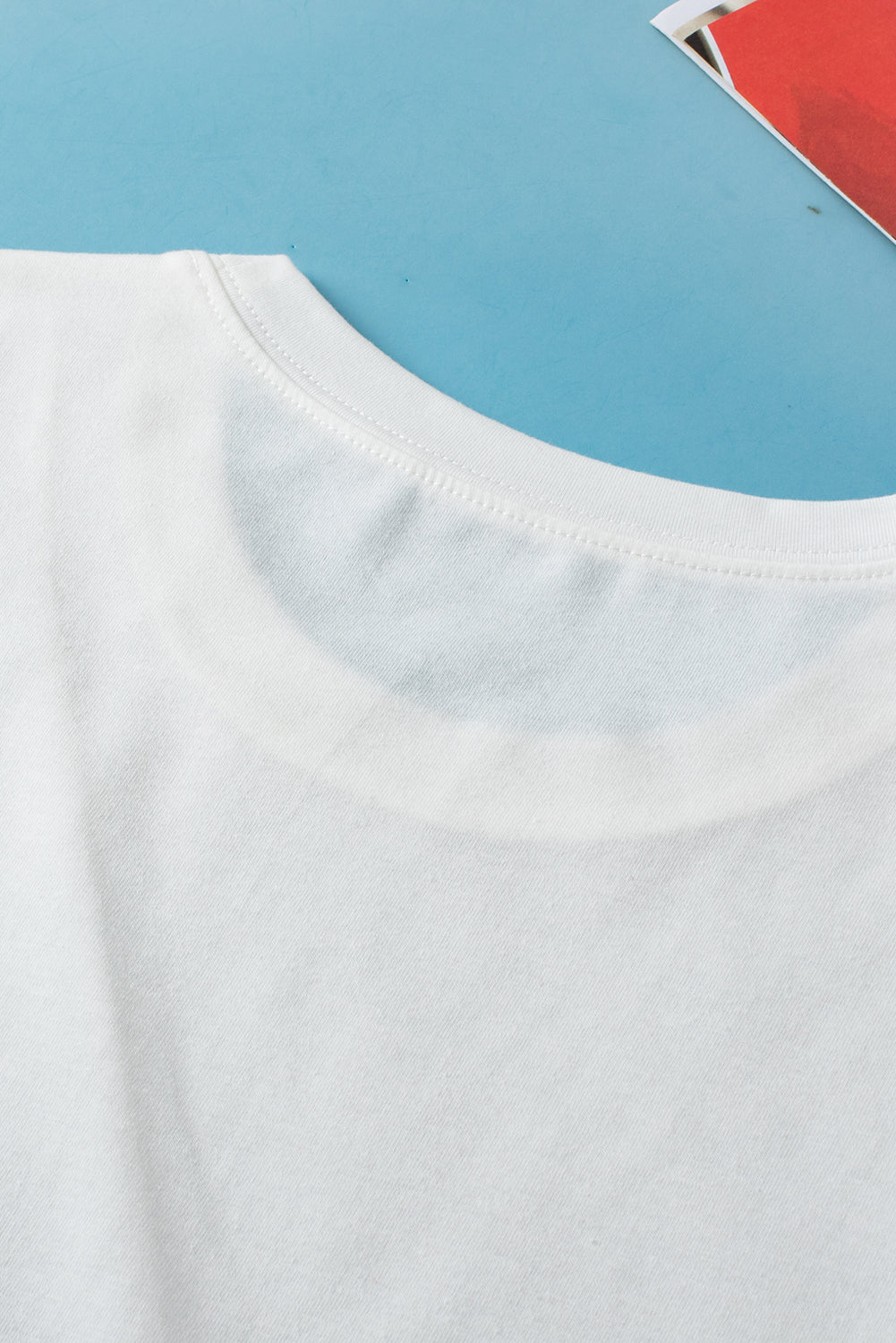 Close-up of a white shirt collar against a blue background
