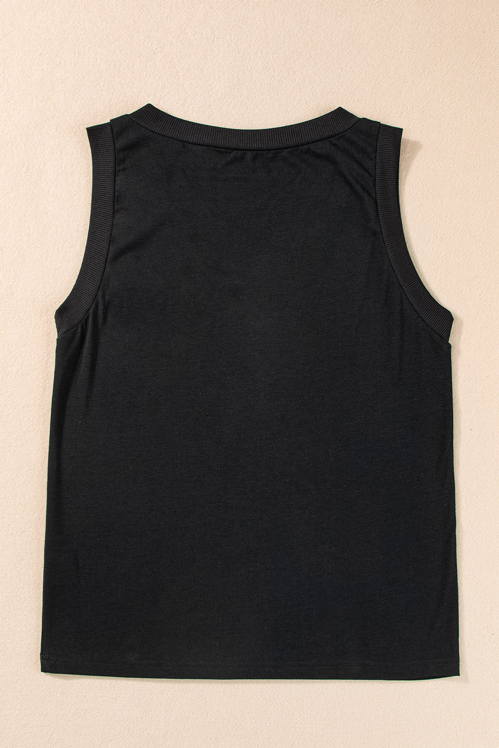 Black sleeveless top on a beige background