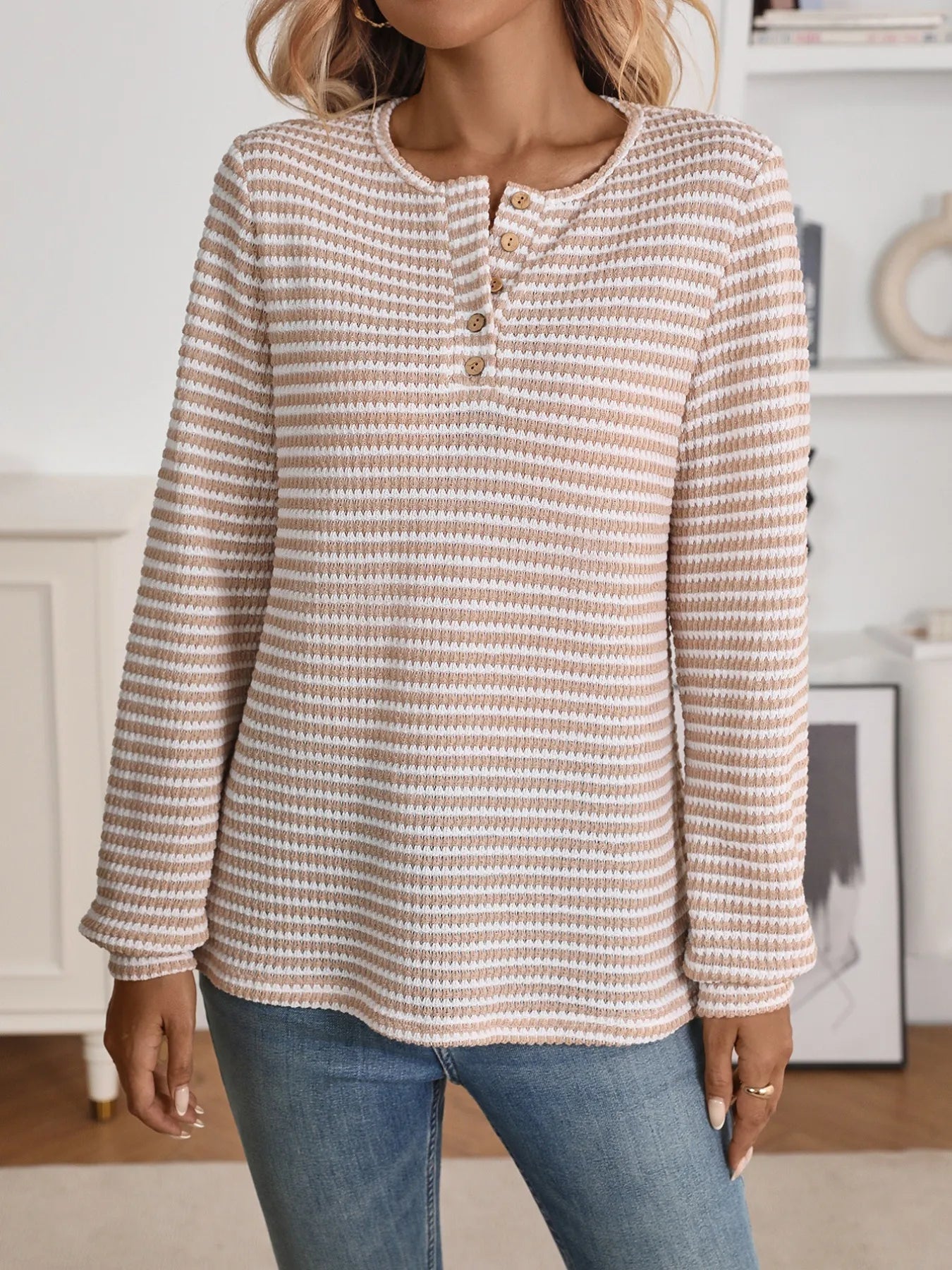 person wearing a long sleeve striped blouse