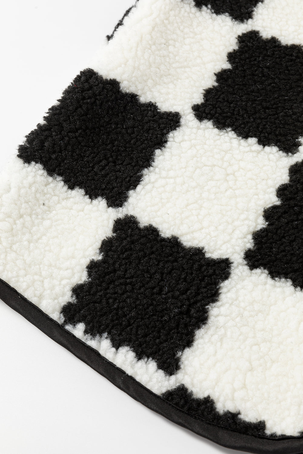 Close-up of a black and white checkered patterned product on a white background