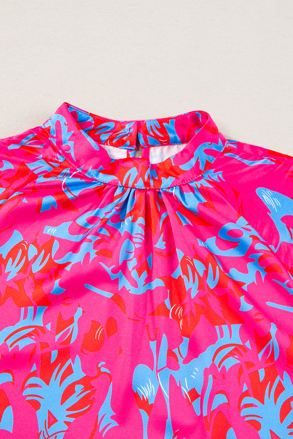 Pink and blue floral dress on a light gray background