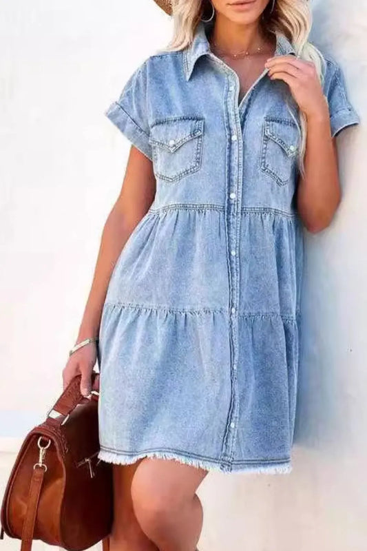 Woman wearing a denim dress against a white background