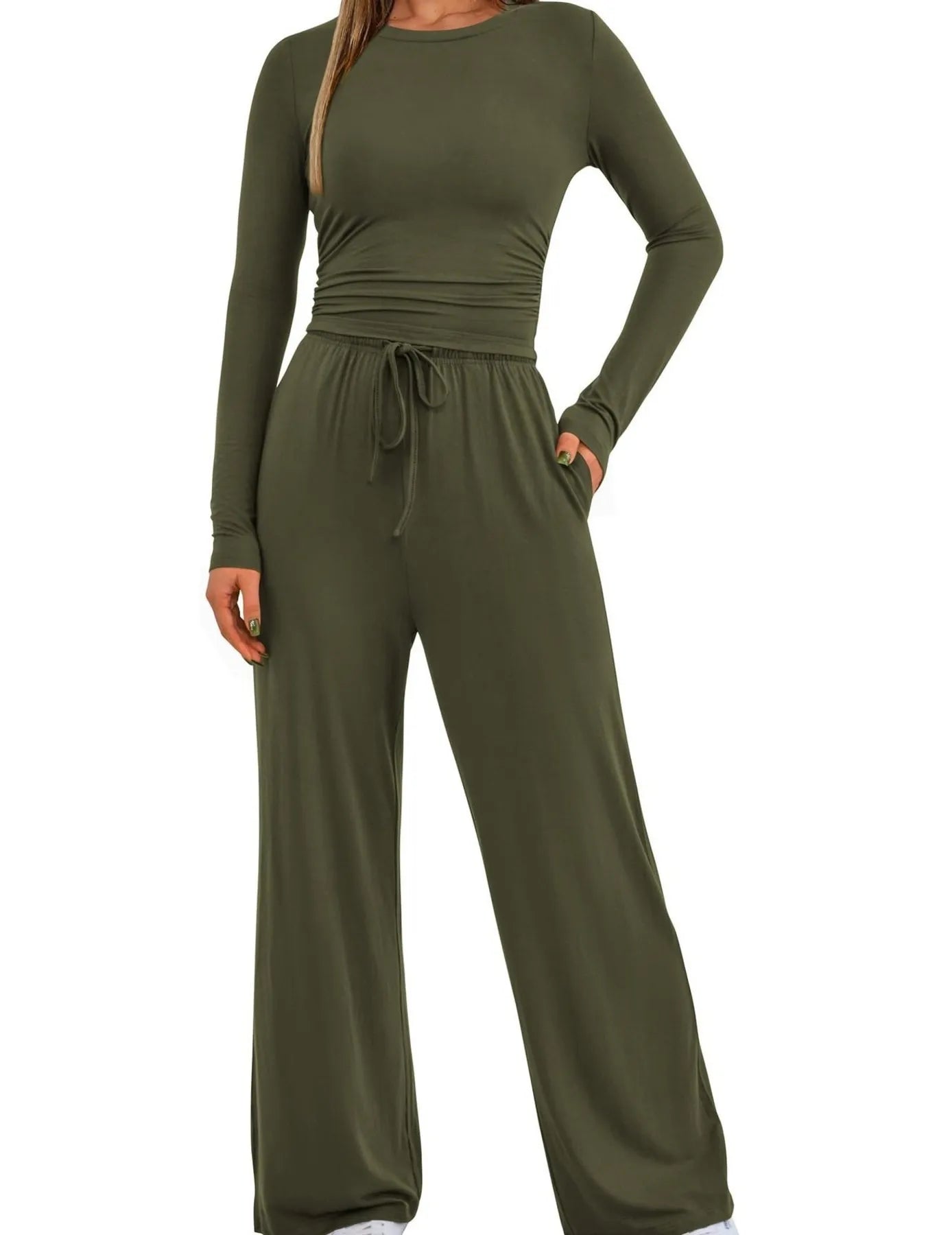 Green jumpsuit with long sleeves and wide-leg pants on a white background