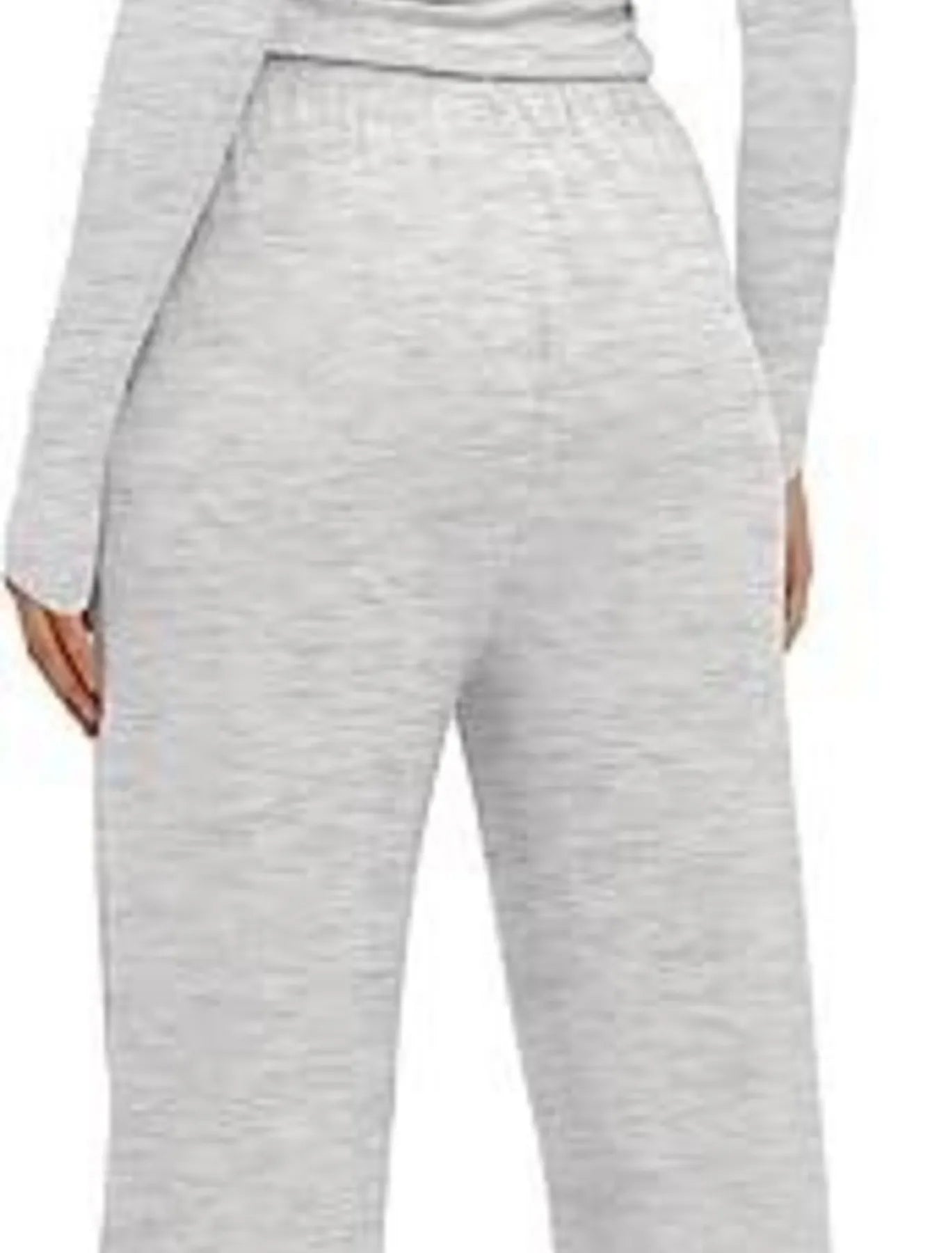 Gray sweatpants worn by a person on a white background