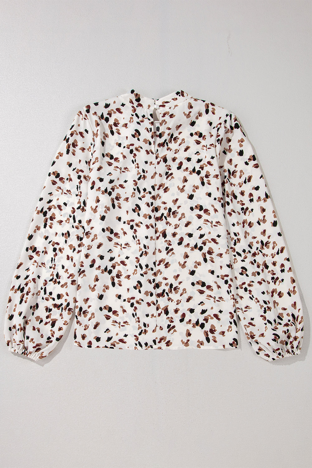 Floral patterned blouse on a light gray background