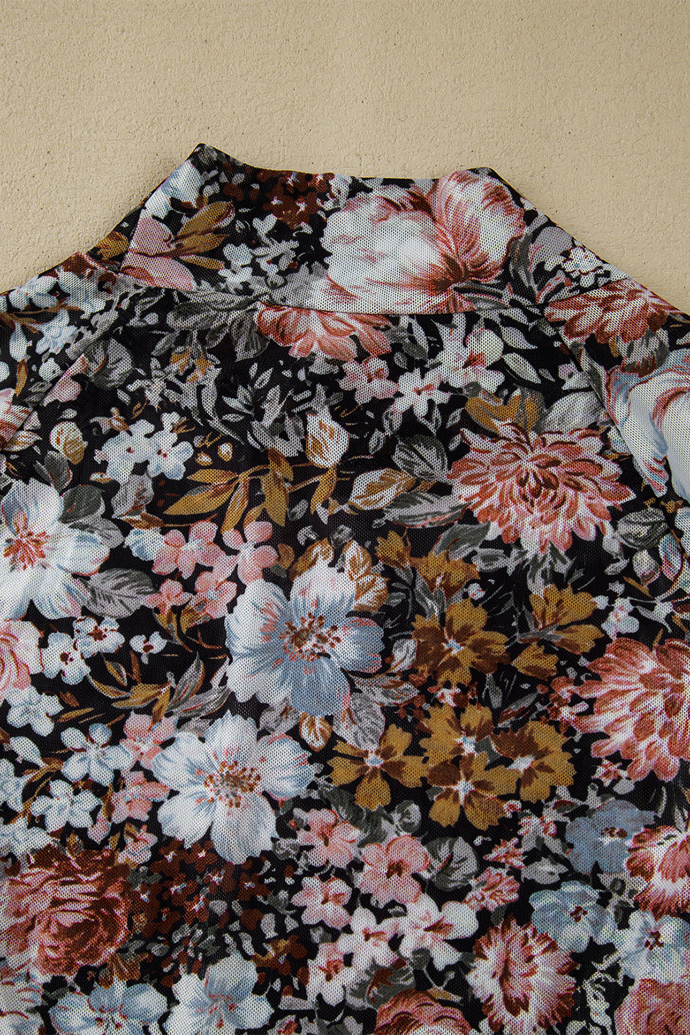 Floral patterned fabric on a beige background