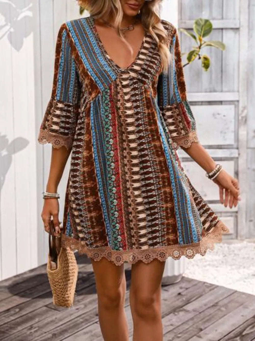 Woman wearing a patterned dress on a wooden deck