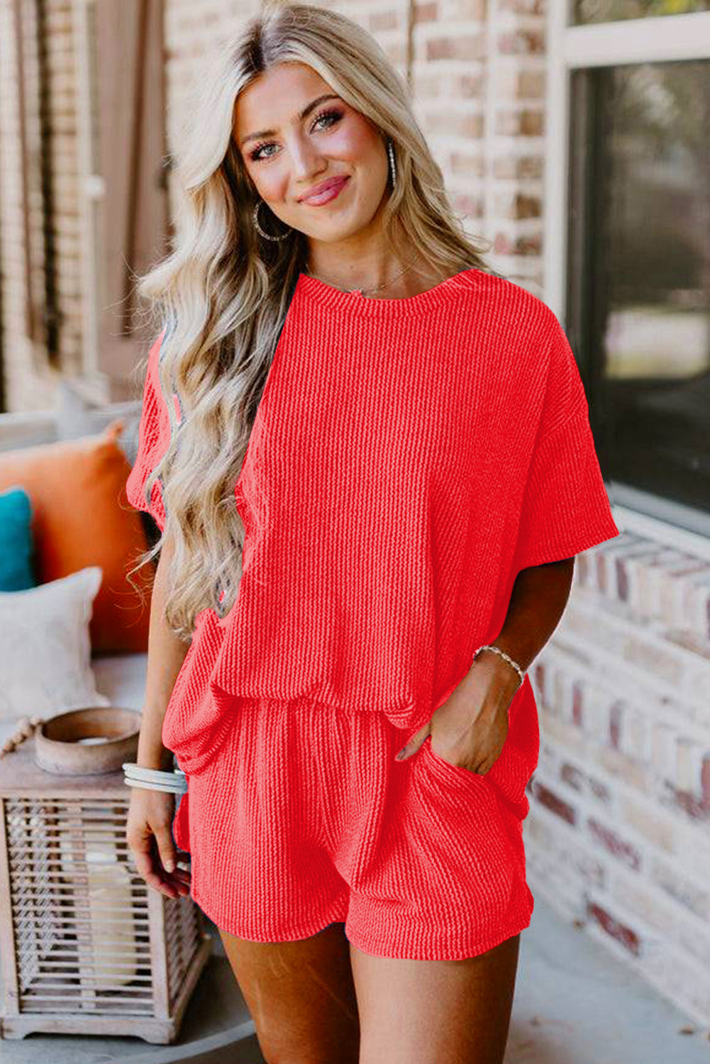 Woman wearing a red outfit standing outdoors with a blurred background