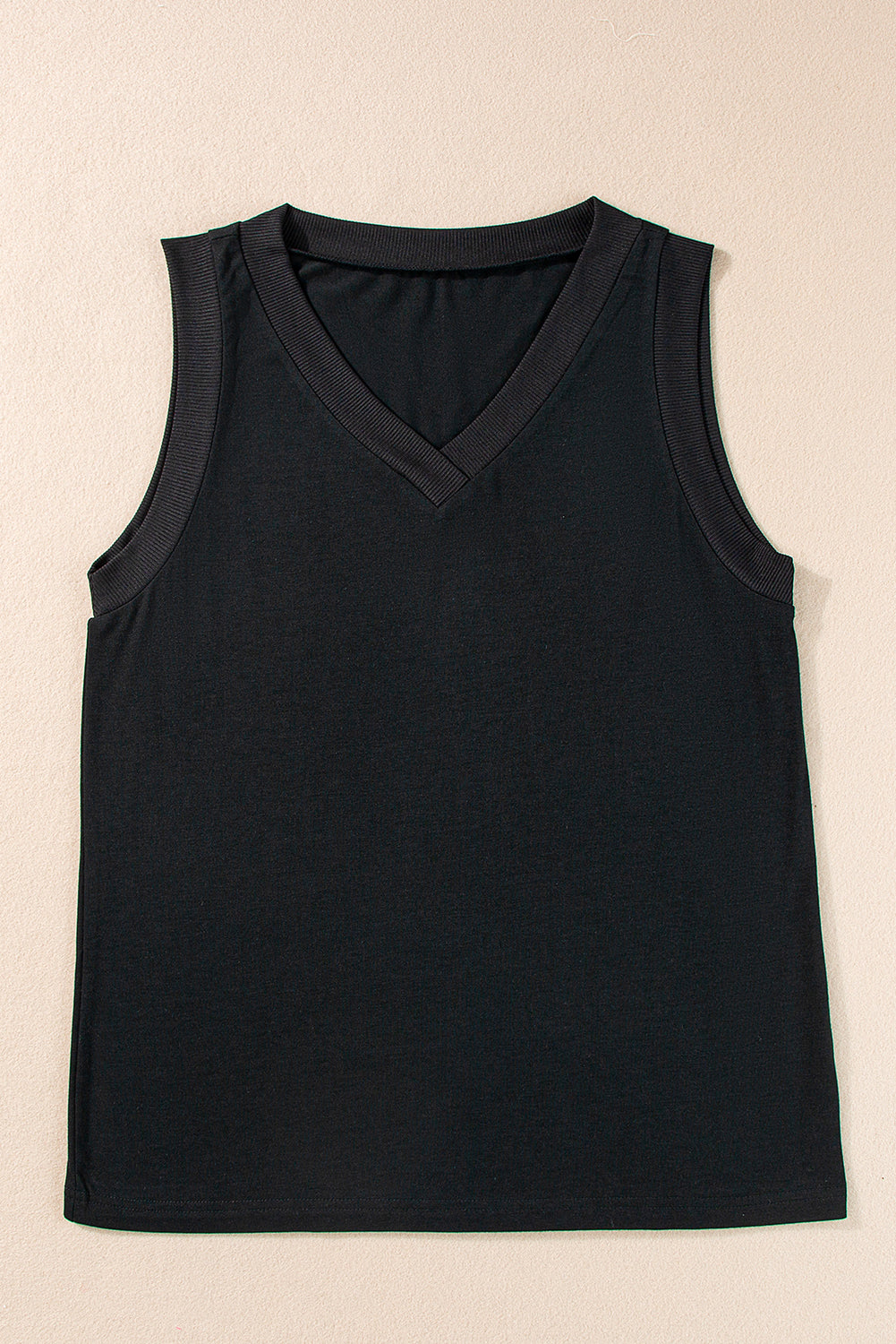 Black tank top on a beige background