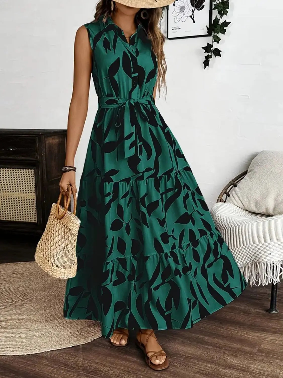 Woman wearing a green dress with black leaf pattern indoors.