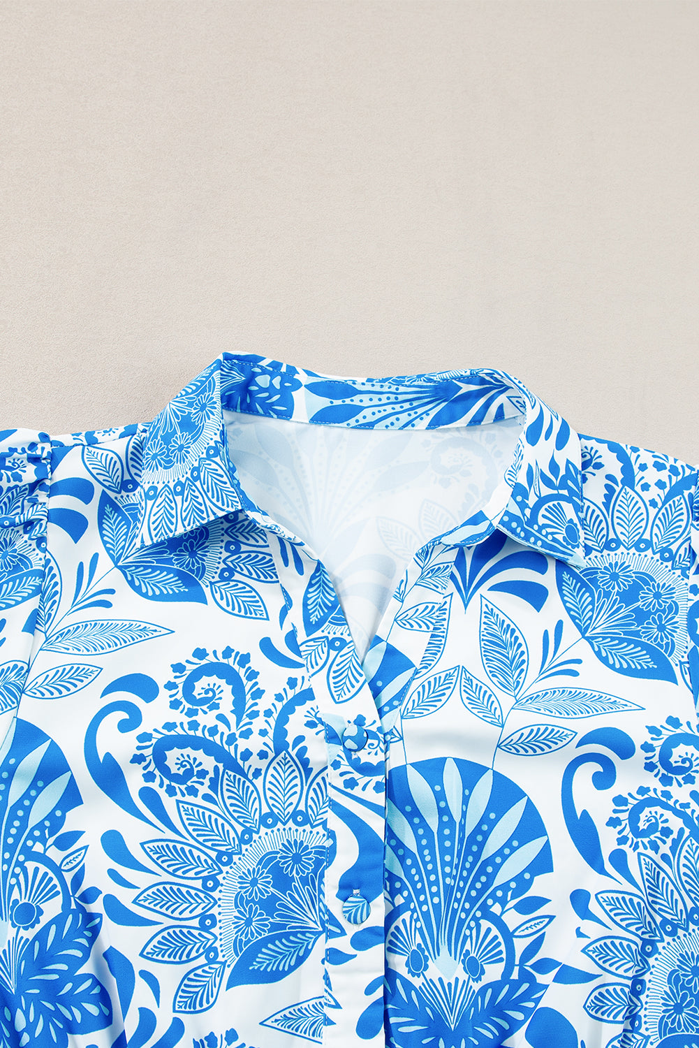 Blue and white patterned shirt on a beige background