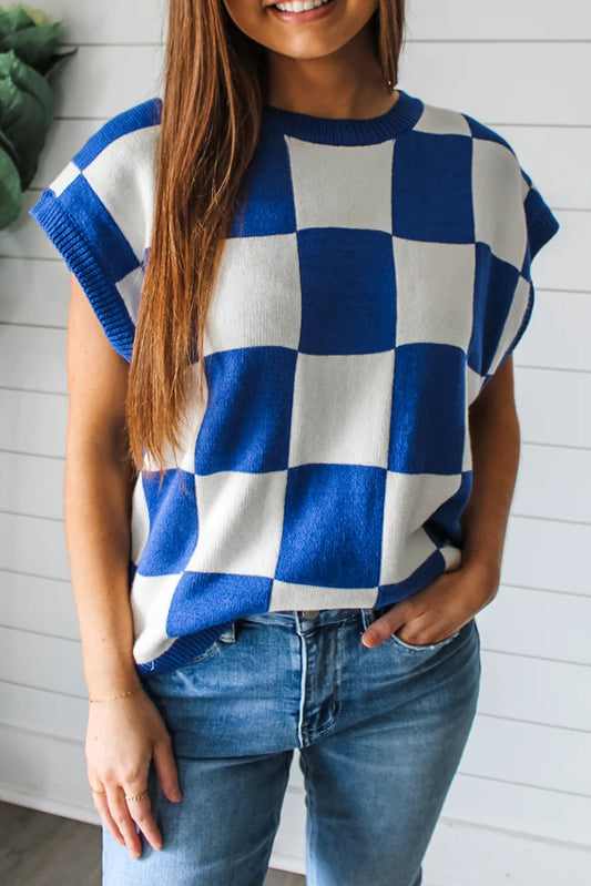 Person wearing a blue and white checkered sweater with a white background