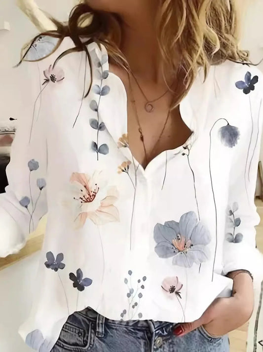 White blouse with floral and butterfly patterns worn by a person.
