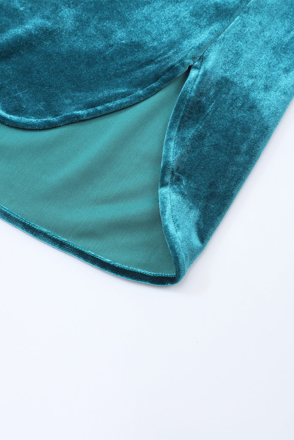 Teal velvet fabric on a white background