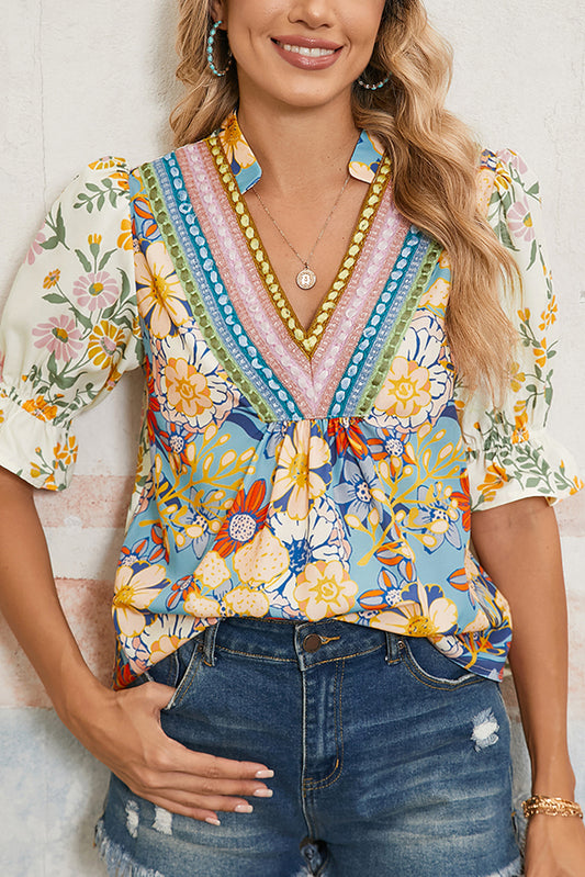 Woman wearing a colorful floral blouse with a white background
