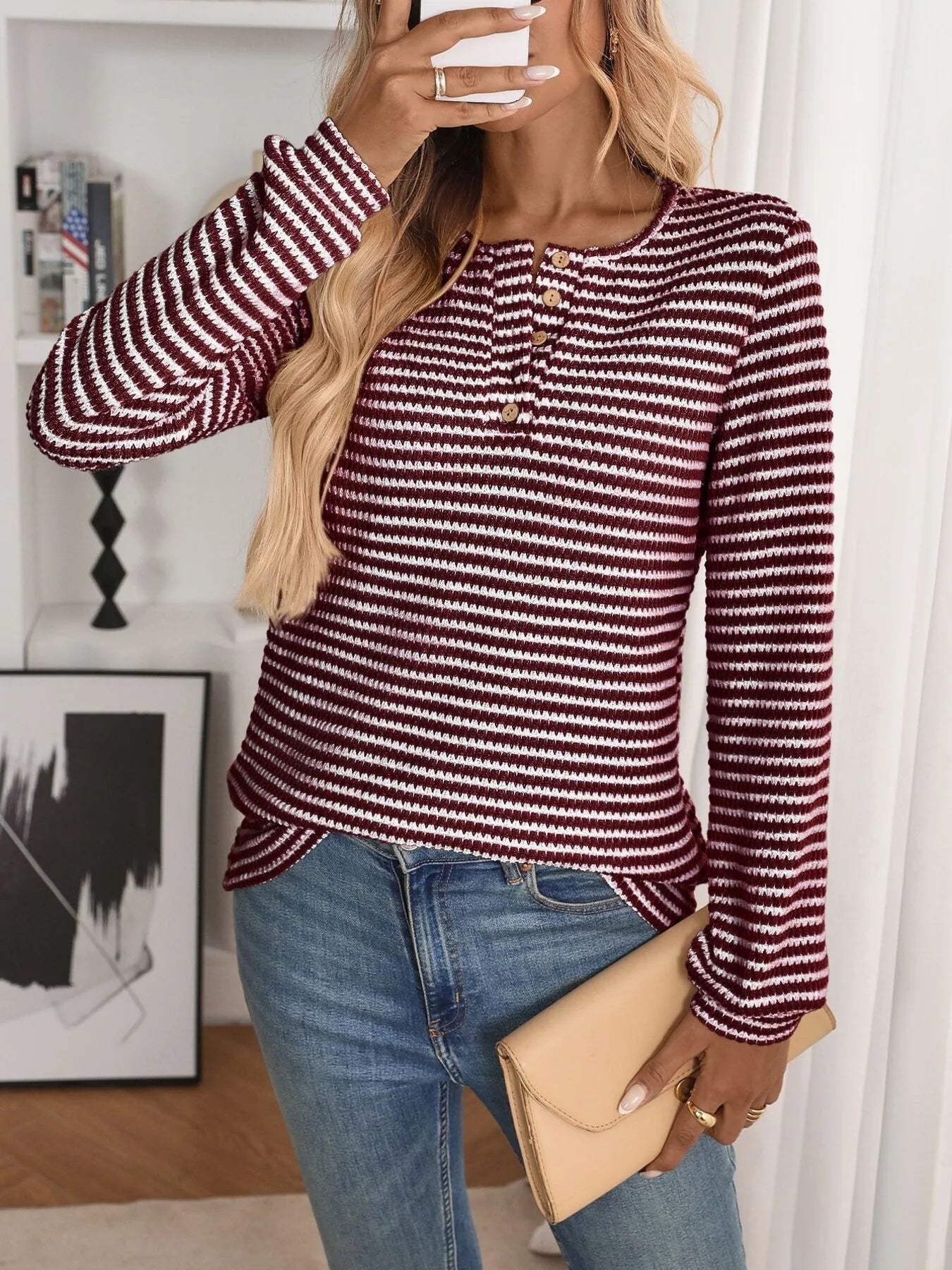 person wearing a long sleeve striped blouse