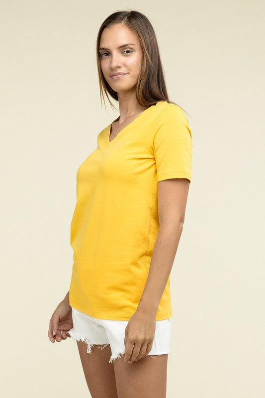 Woman wearing a yellow t-shirt and white shorts on a beige background