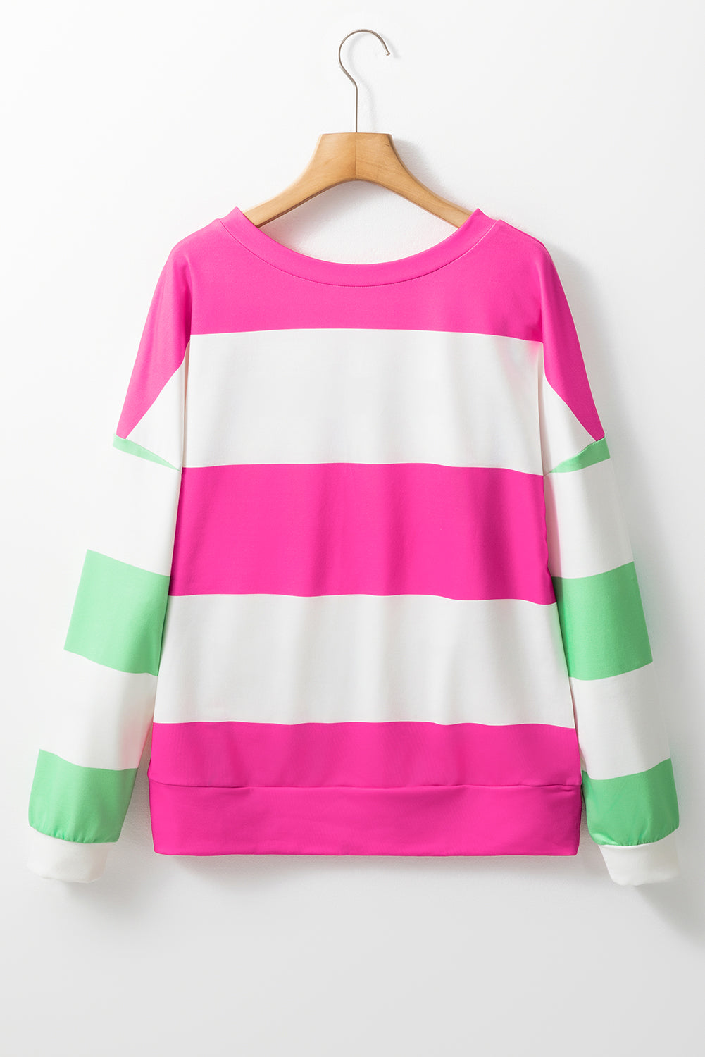 Colorful striped sweater on a hanger against a white background