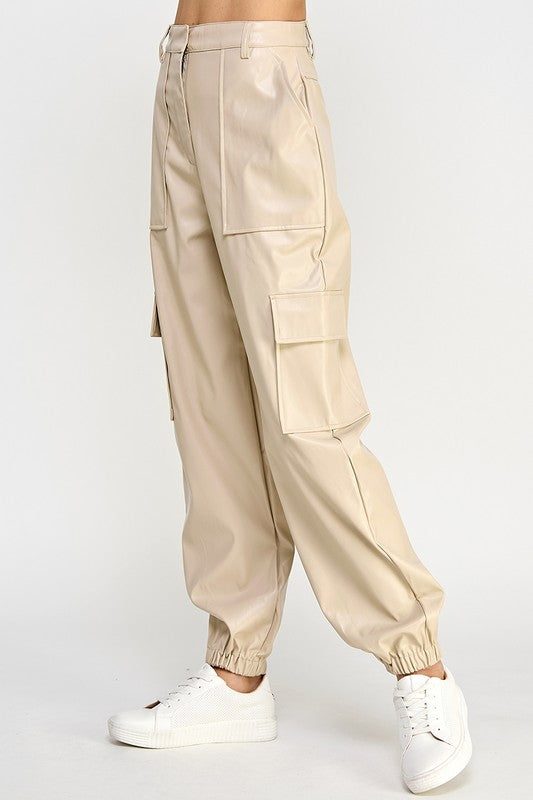 Beige cargo pants worn by a person on a white background