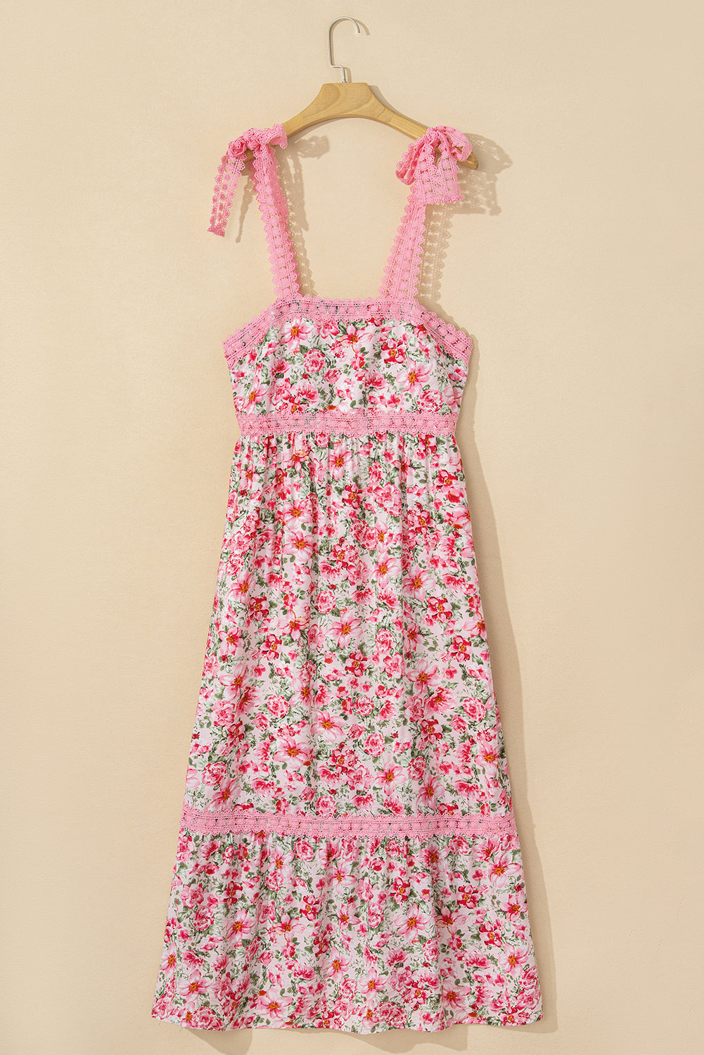 Floral dress with pink straps on a beige background