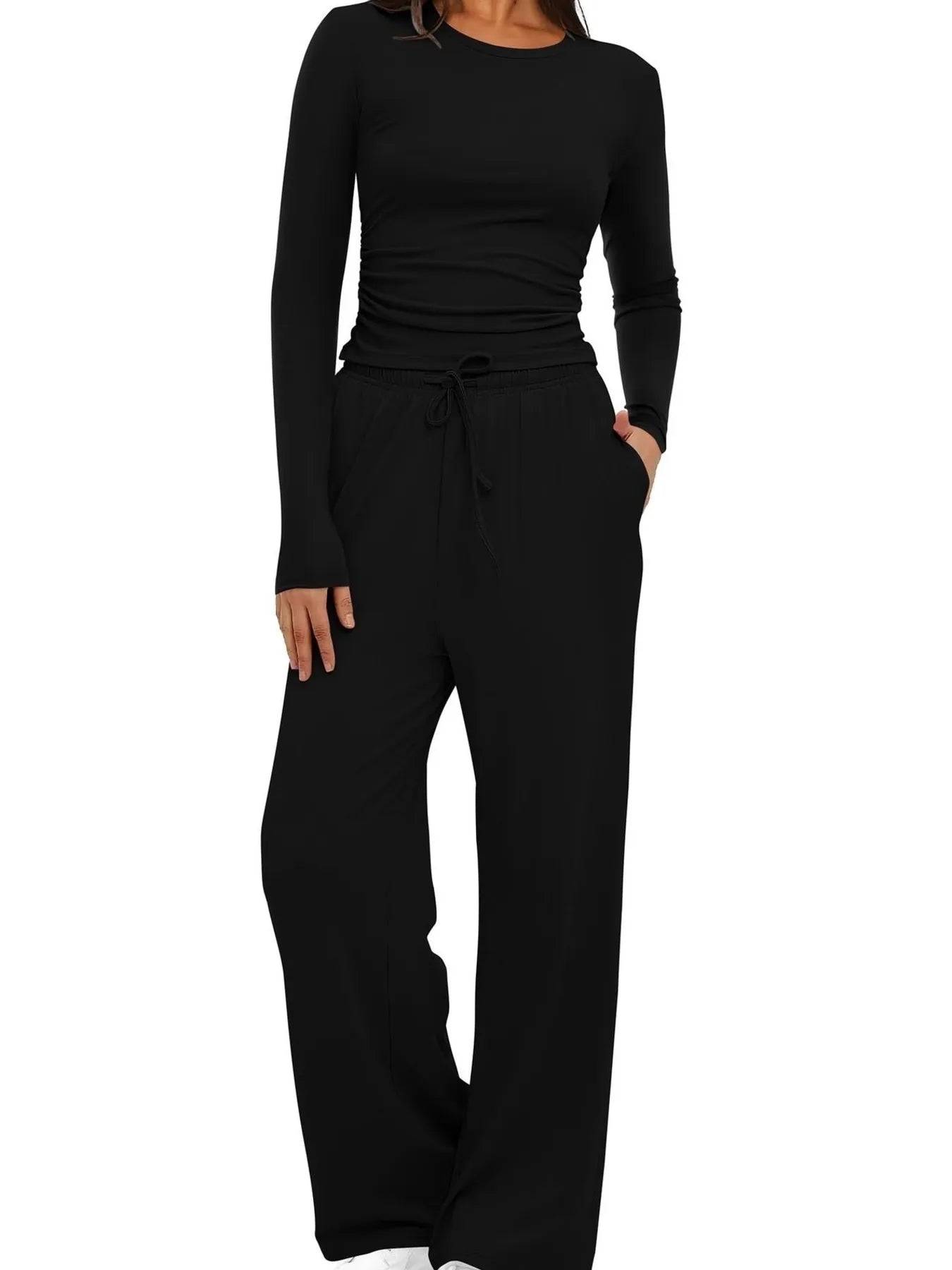 Black long-sleeve top and wide-leg pants set on a white background