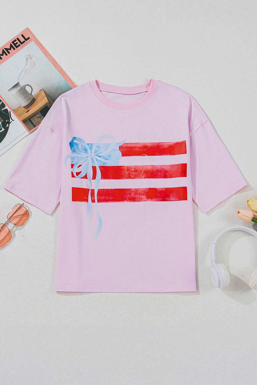 Pink t-shirt with graphic design on a white surface