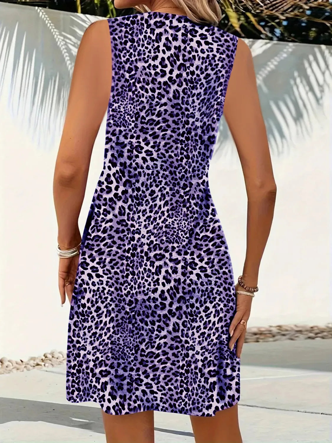 Person wearing a purple leopard print dress with a blurred background