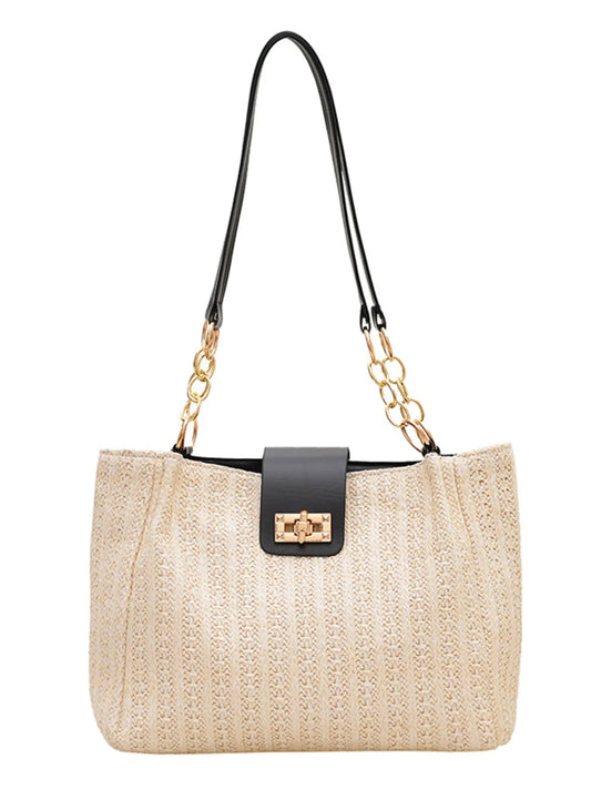 Beige straw handbag with black strap and gold chain on a white background