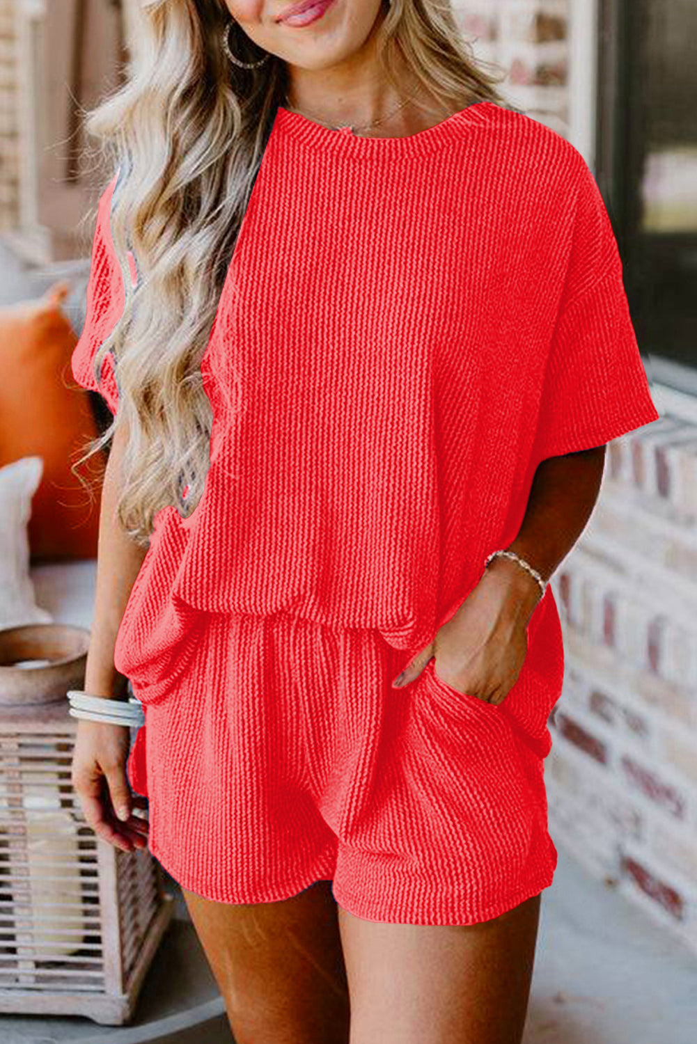 Woman wearing a red romper with a blurred background