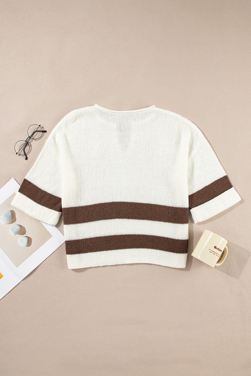 White sweater with brown stripes on a beige background