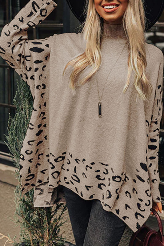 Woman wearing a beige sweater with leopard print sleeves outdoors.