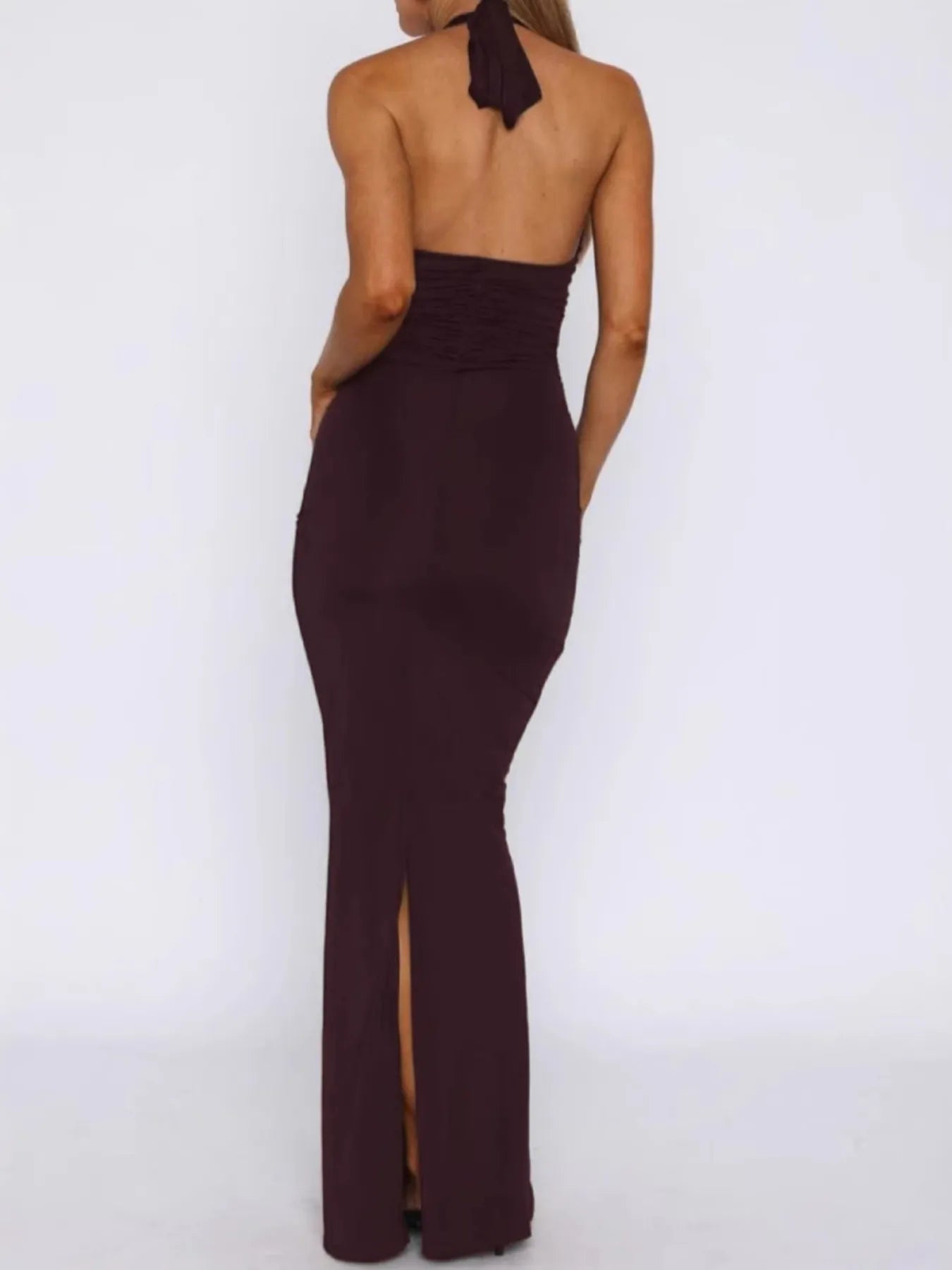 Dark brown halter neck gown with a slit on a white background