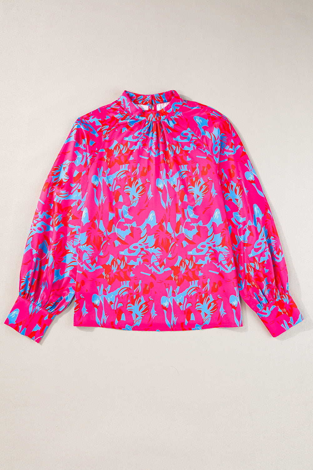 Pink floral long-sleeve top on a beige background