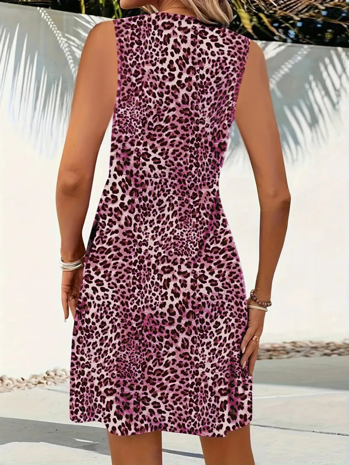 Person wearing a purple leopard print dress with a blurred background