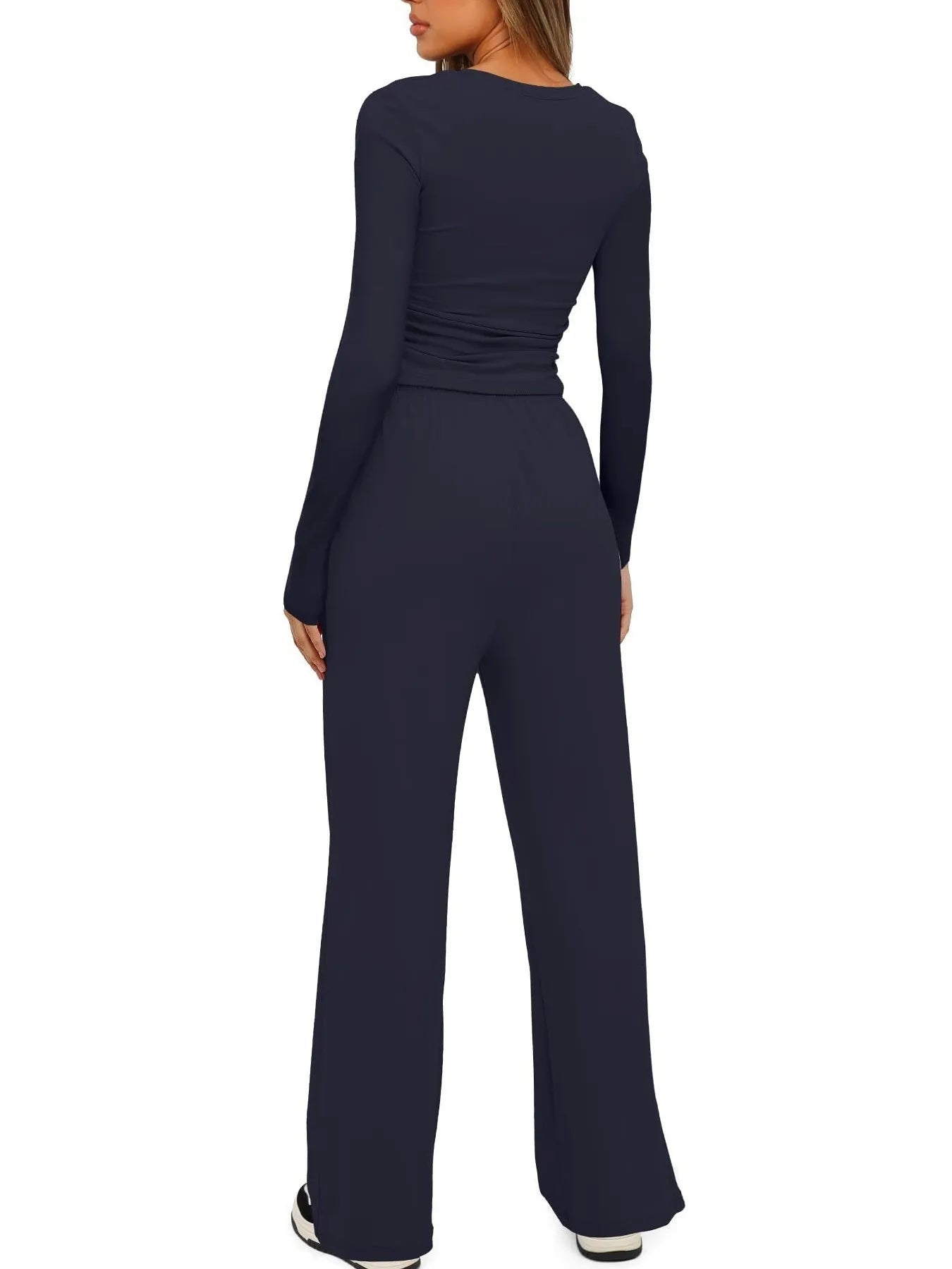 Navy blue jumpsuit worn by a person on a white background