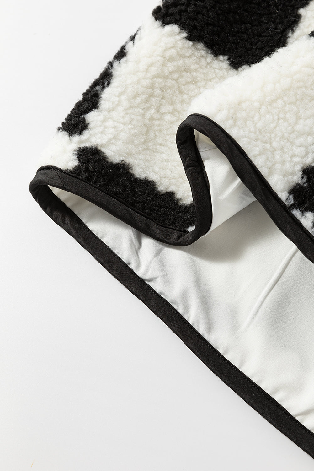 Close-up of a black and white patterned fabric with a visible brand logo.