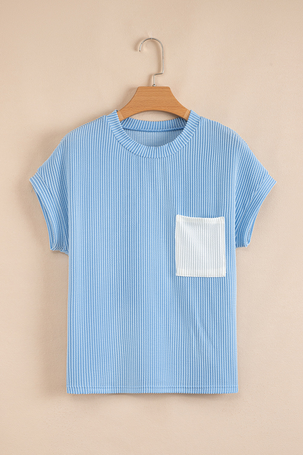 Blue striped t-shirt with a white pocket on a beige background