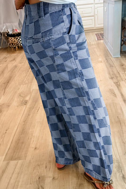 Person wearing blue checkered pants on a wooden floor.