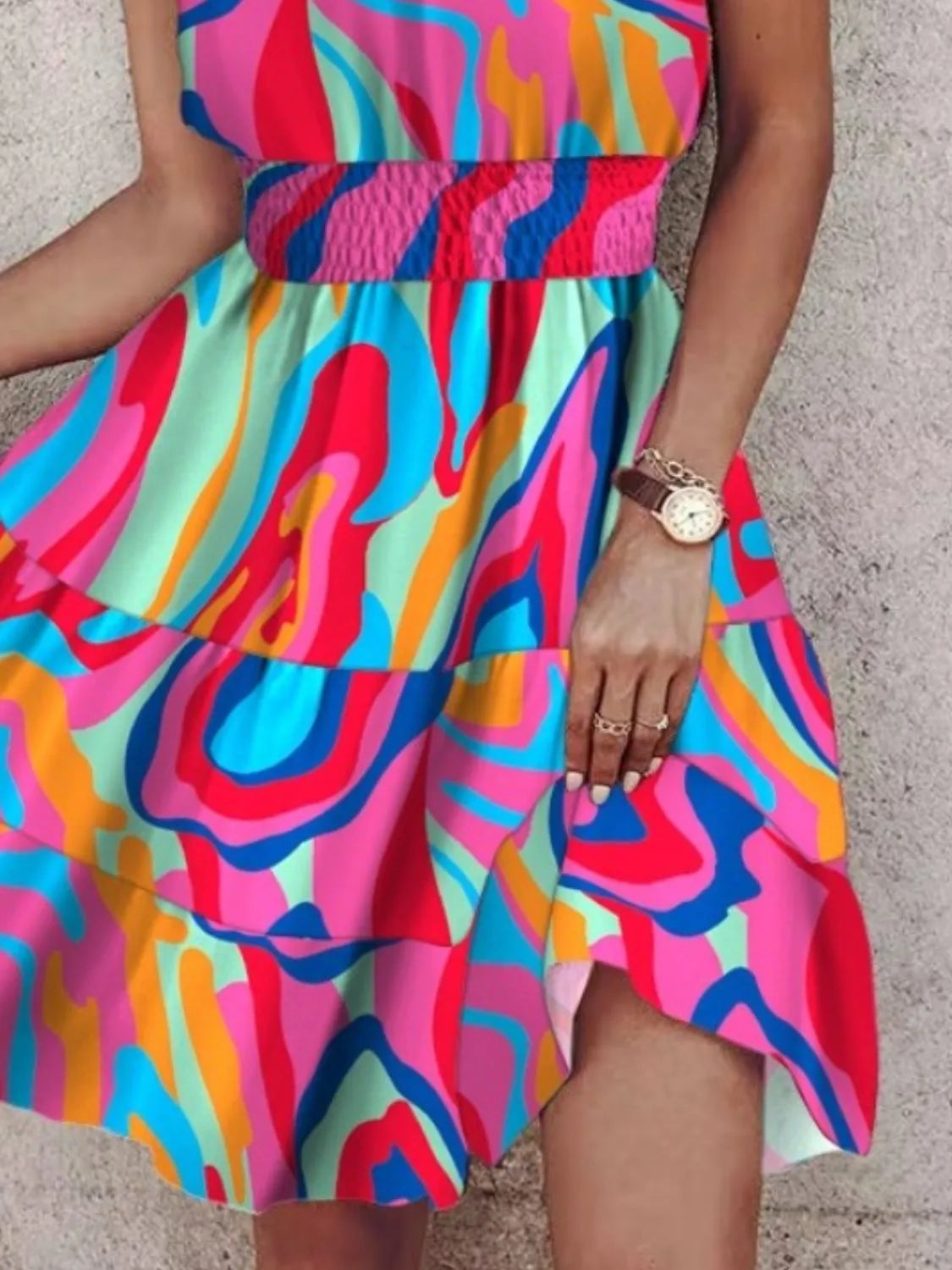 Colorful abstract patterned dress worn by a person.