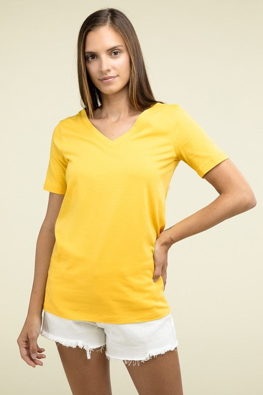 Woman wearing a yellow t-shirt and white shorts on a beige background